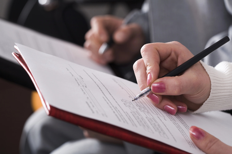 researchers filling out a survey by hand.