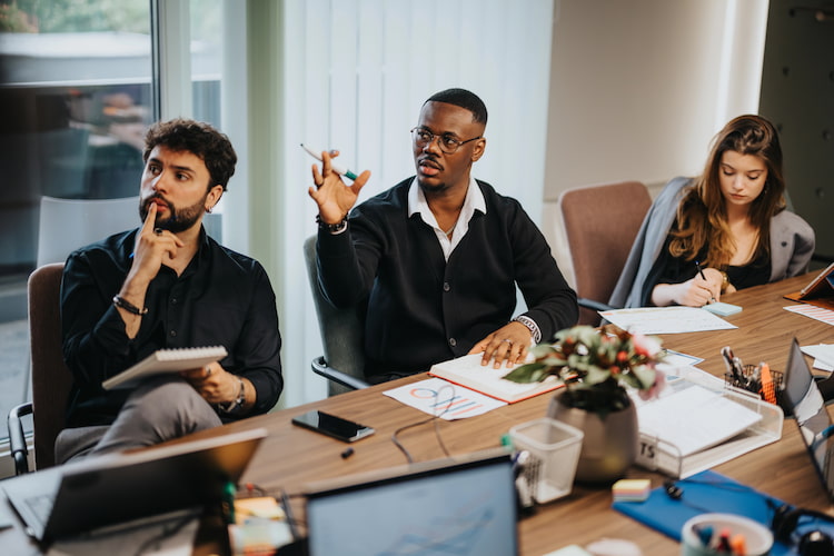 employees at a desk, engaged in their work 
